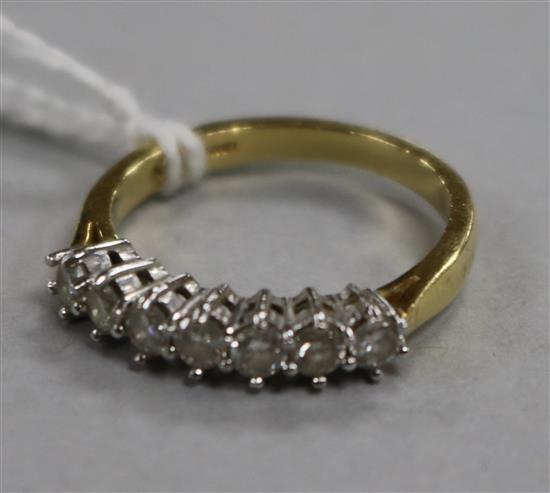 A modern 18ct gold and seven stone diamond set half hoop ring, size M.